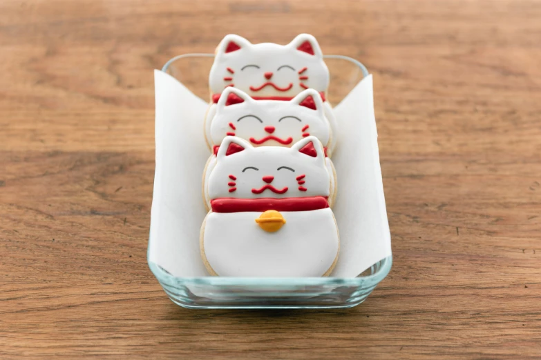 a row of small cats sitting in a glass bowl