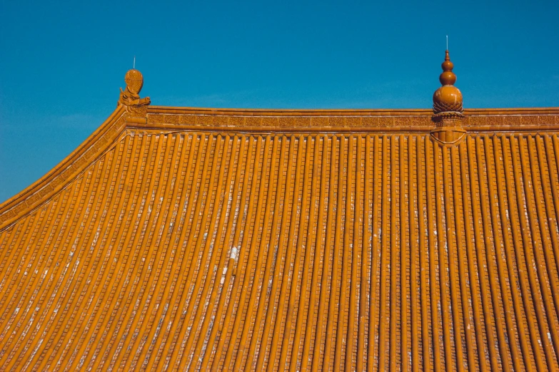 orange tiled roof with two tall brown clock tower