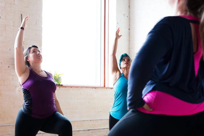 two women are doing an exercise while one looks up at her