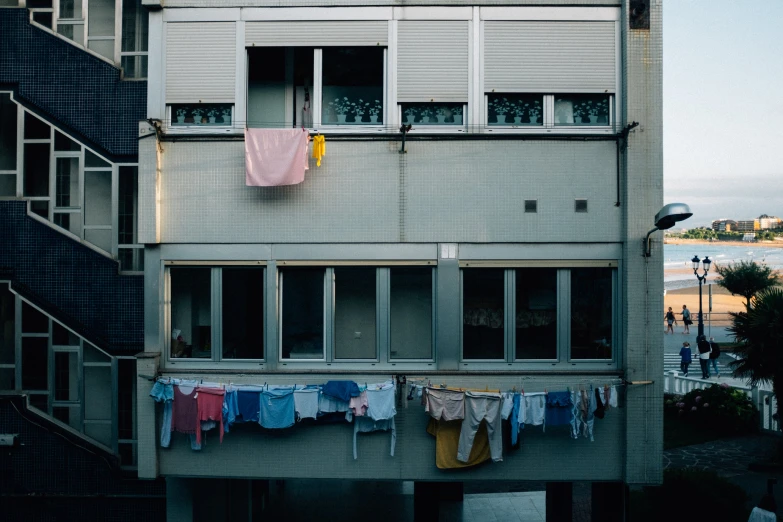 a apartment building has a clothes line outside of the windows