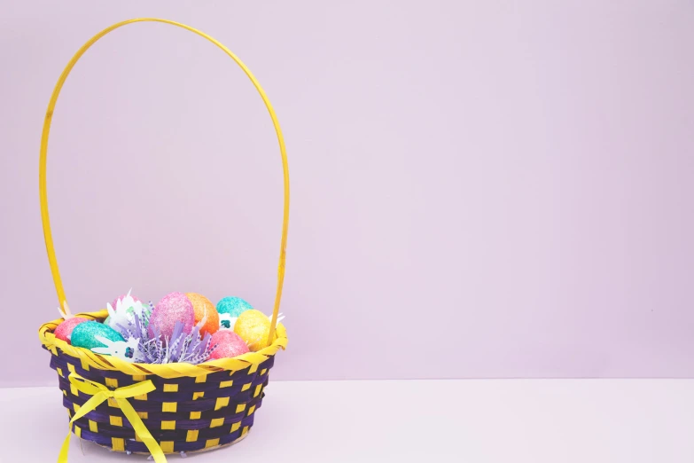 a yellow basket with many candies in it