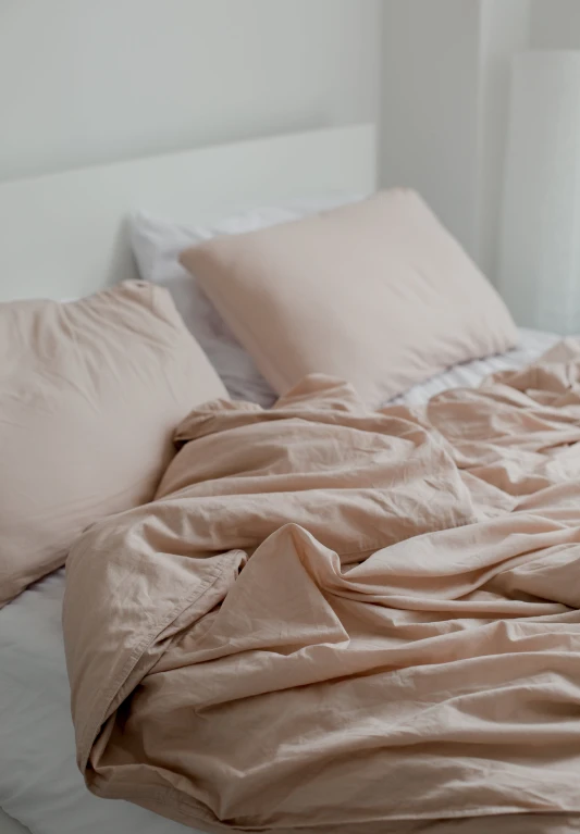 there is a beige blanket on top of the bed