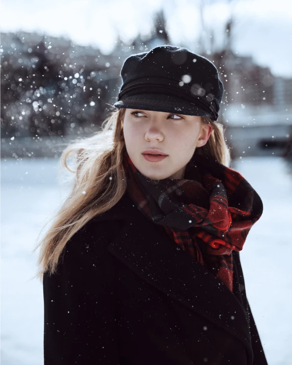 the young woman is wearing a cap and scarf