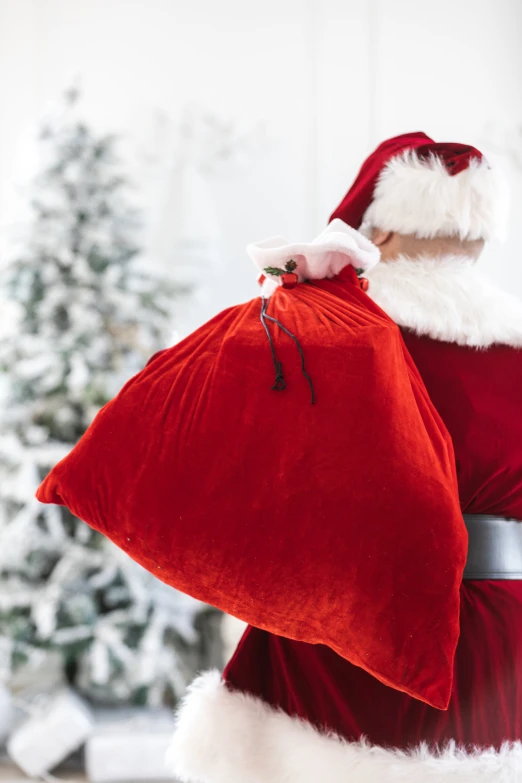 a santa clause is standing and holding some red items