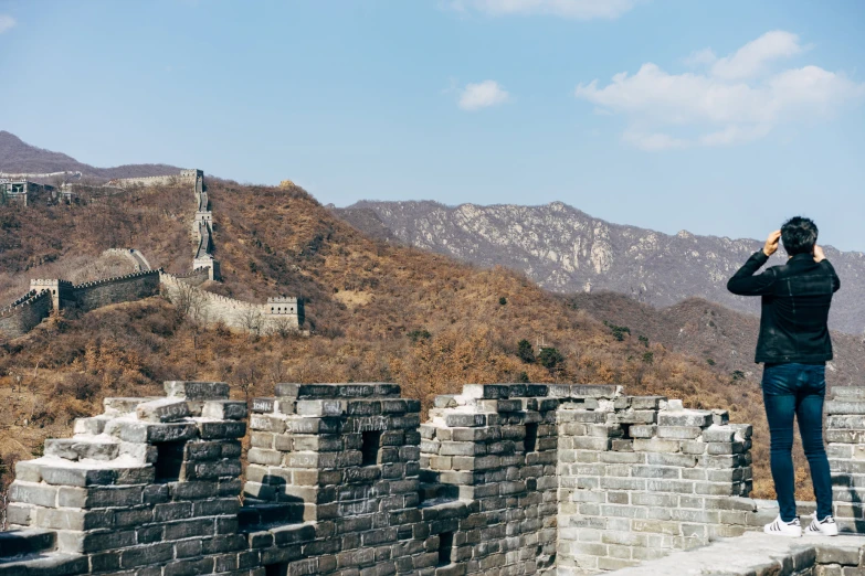 a person standing on the side of a long wall