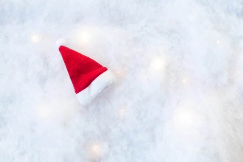 red santa hat laying on top of white fur