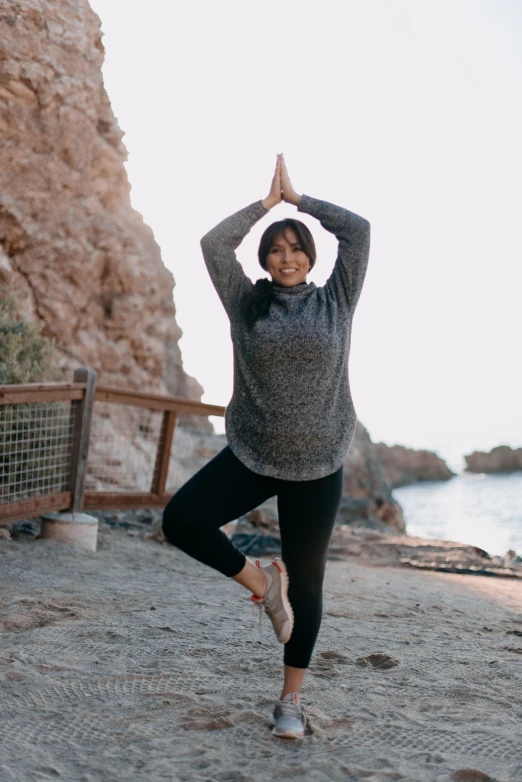 a woman with a smile on her face in a yoga pose