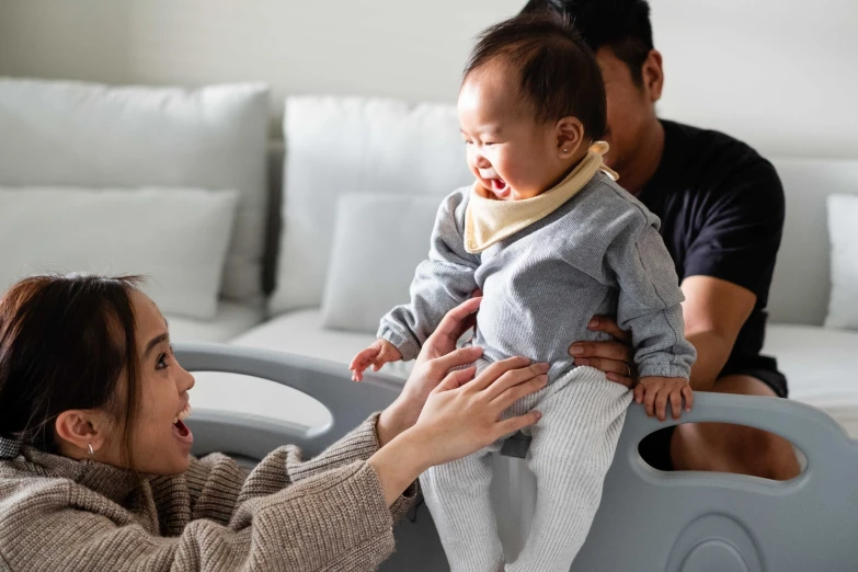 a man and woman are in a large bathtub with a baby in it