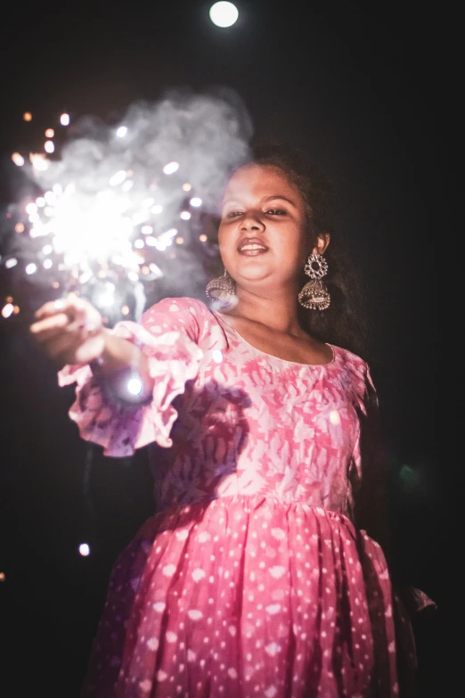 a  holding a sparkler in her hand