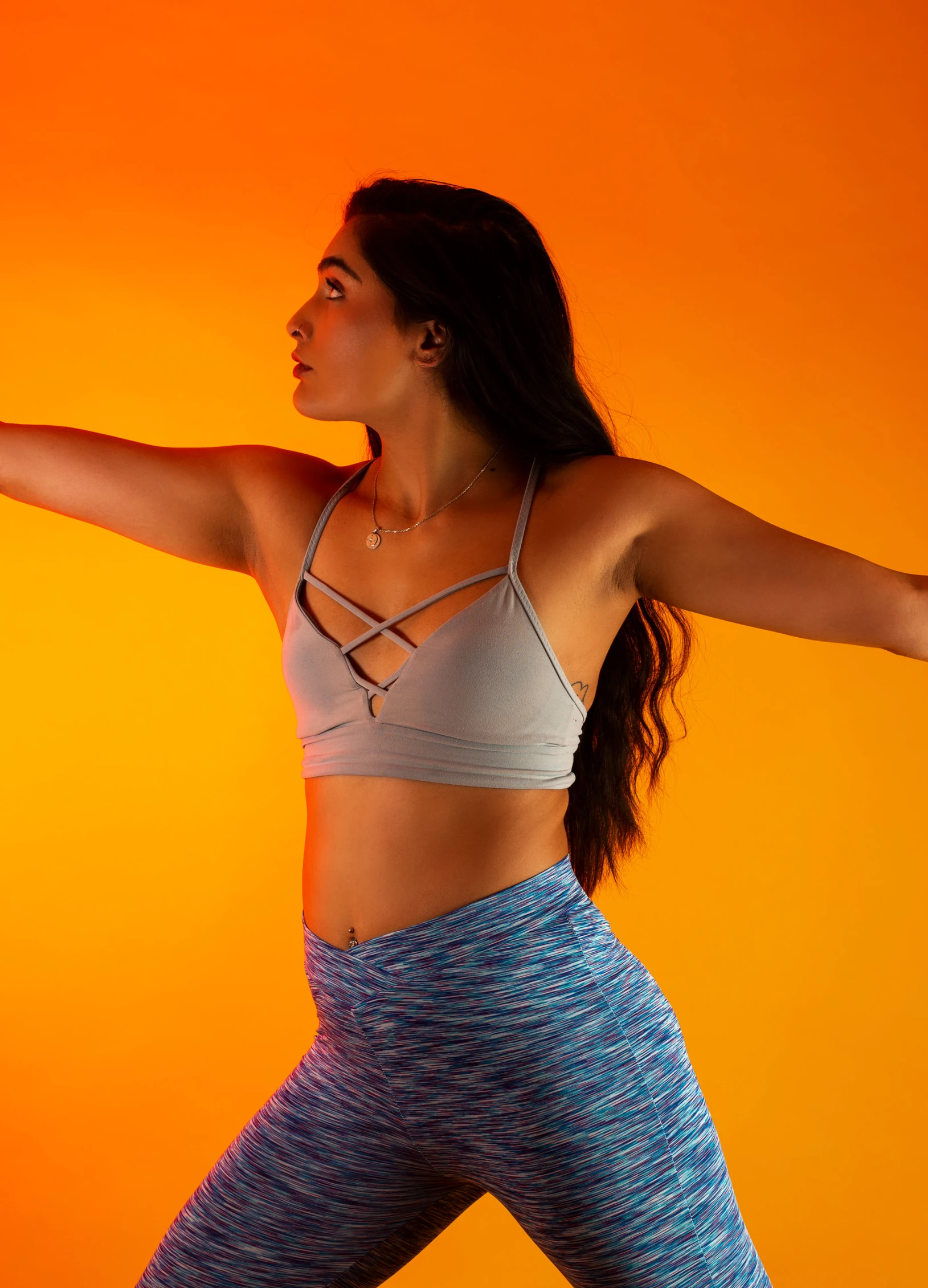 a girl holding an orange frisbee standing up