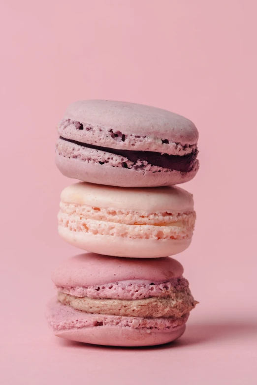 four pink and grey macaroons stacked in rows