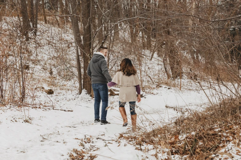 an image of two people walking through the woods