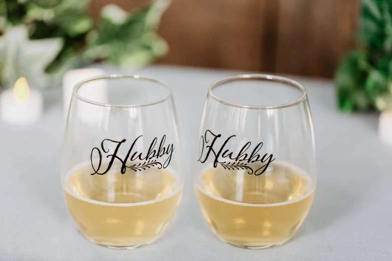 two wine glasses that are sitting on a table
