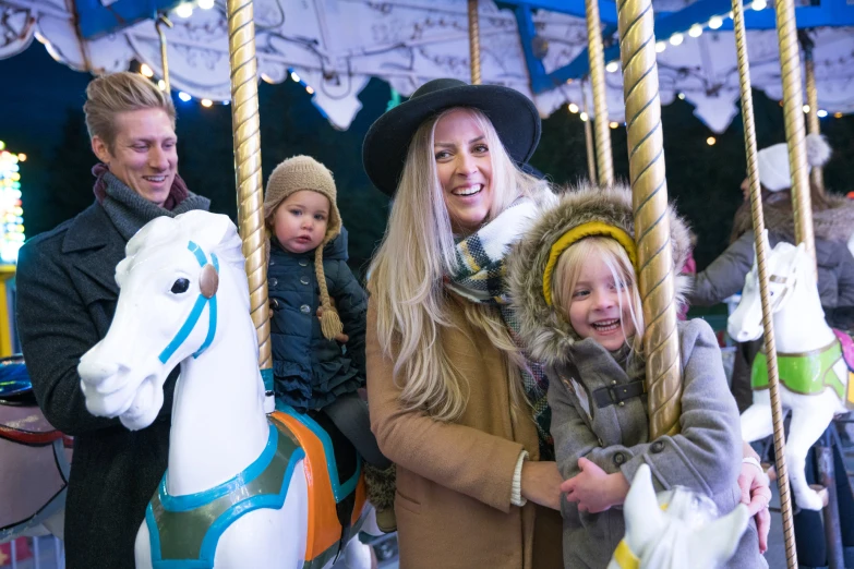 a family on the merry go round at a park