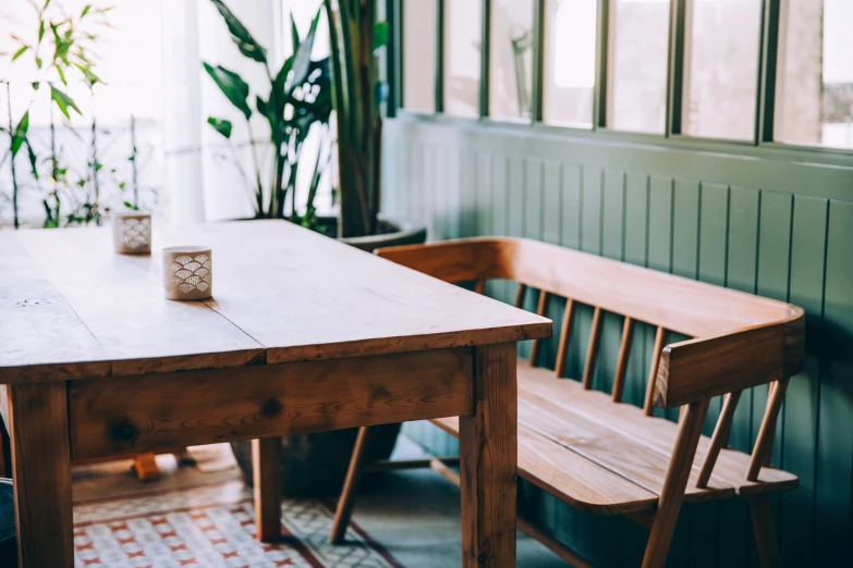 a wooden table with two chairs and a wooden bench