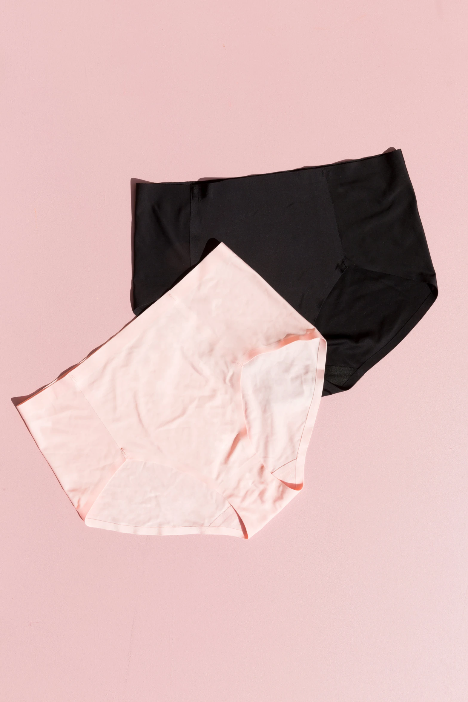 two women's shorties with black and pink trims