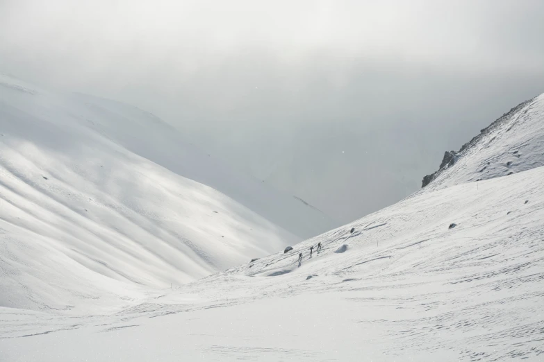 some skiers in the snow on a snowy mountain