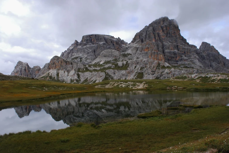 there is a mountain with its reflection in the water