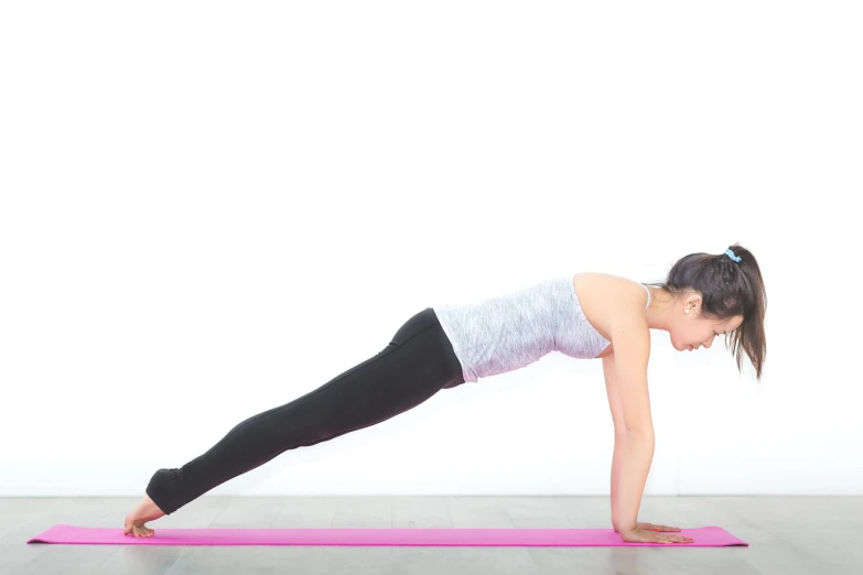 a young woman practices a yoga exercise