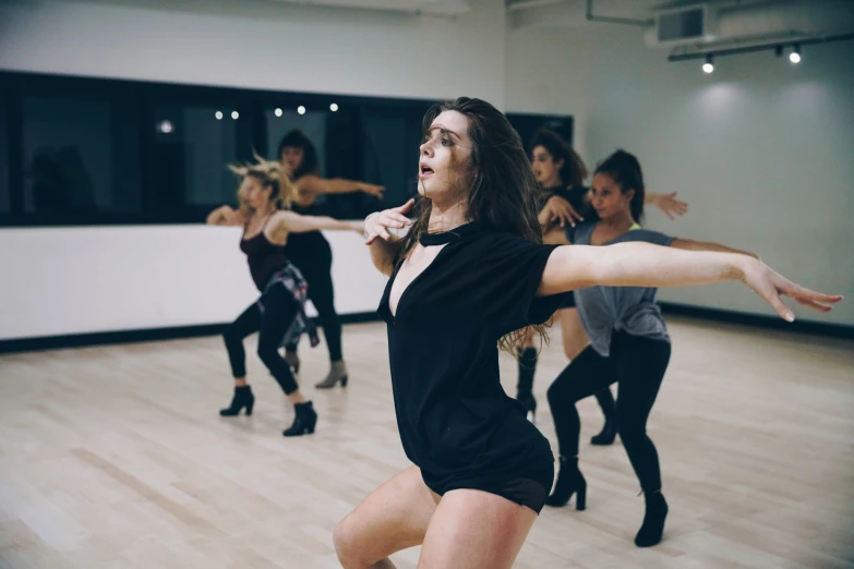 women dancing in dance class in a dark room