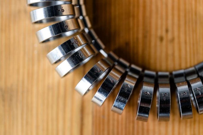 a clock made from steel parts mounted on a wooden structure