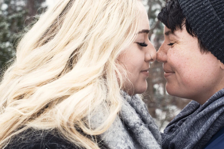 two people looking at each other outside in winter