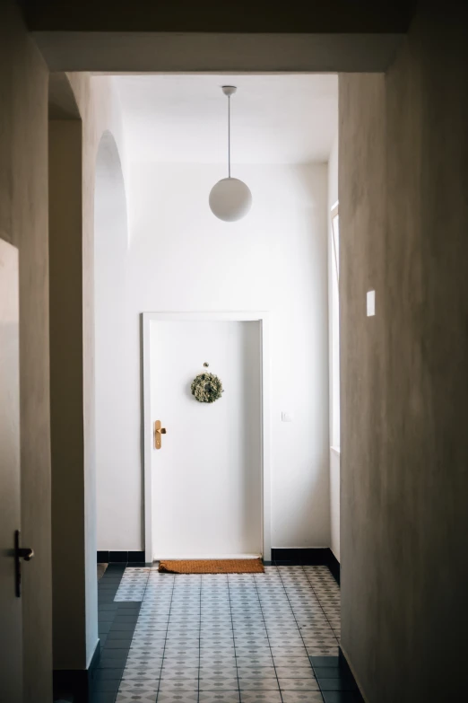 a hallway with a floor and a white door