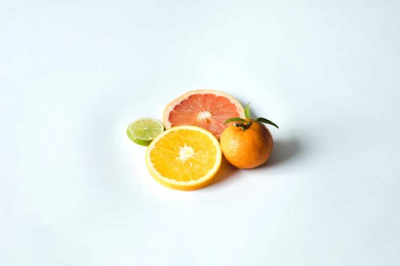 a group of citrus fruit sitting on top of a white surface