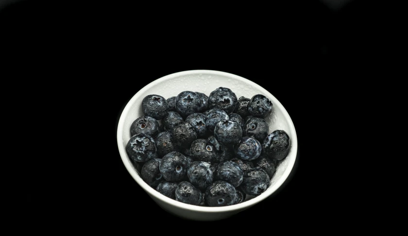 some black berries in a white bowl