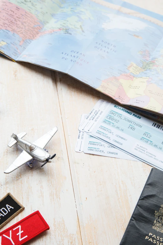 a pair of red keys, passport and a black and white paper