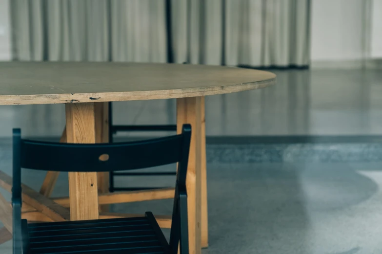 a table with a few black chairs next to it