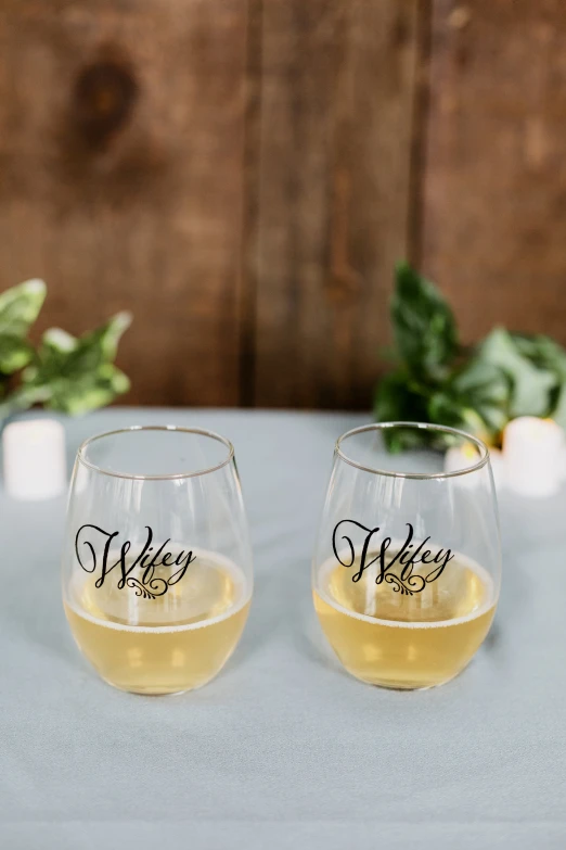 two wine glasses with the names wey and their labels