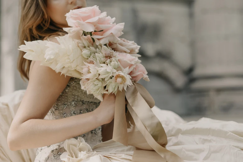 there is a woman holding a bouquet of flowers