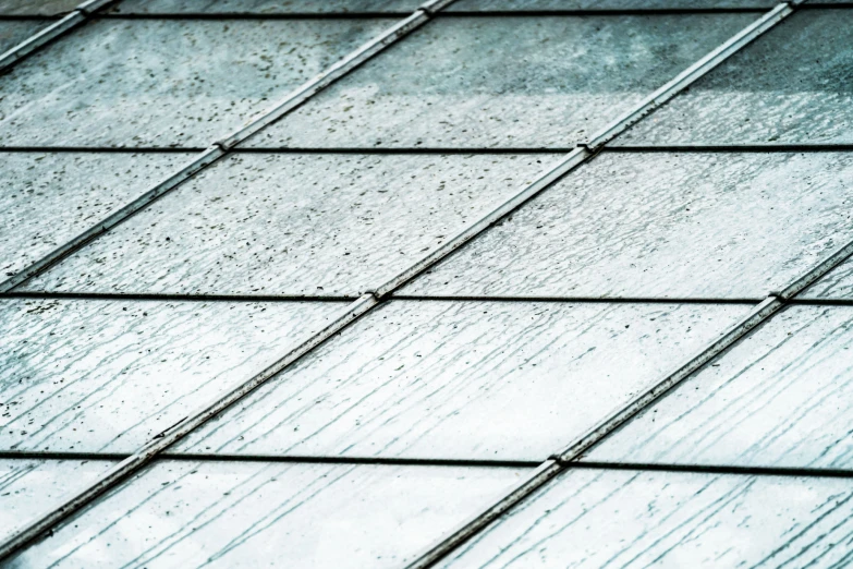 close up view of rain and snow falling on metal grates