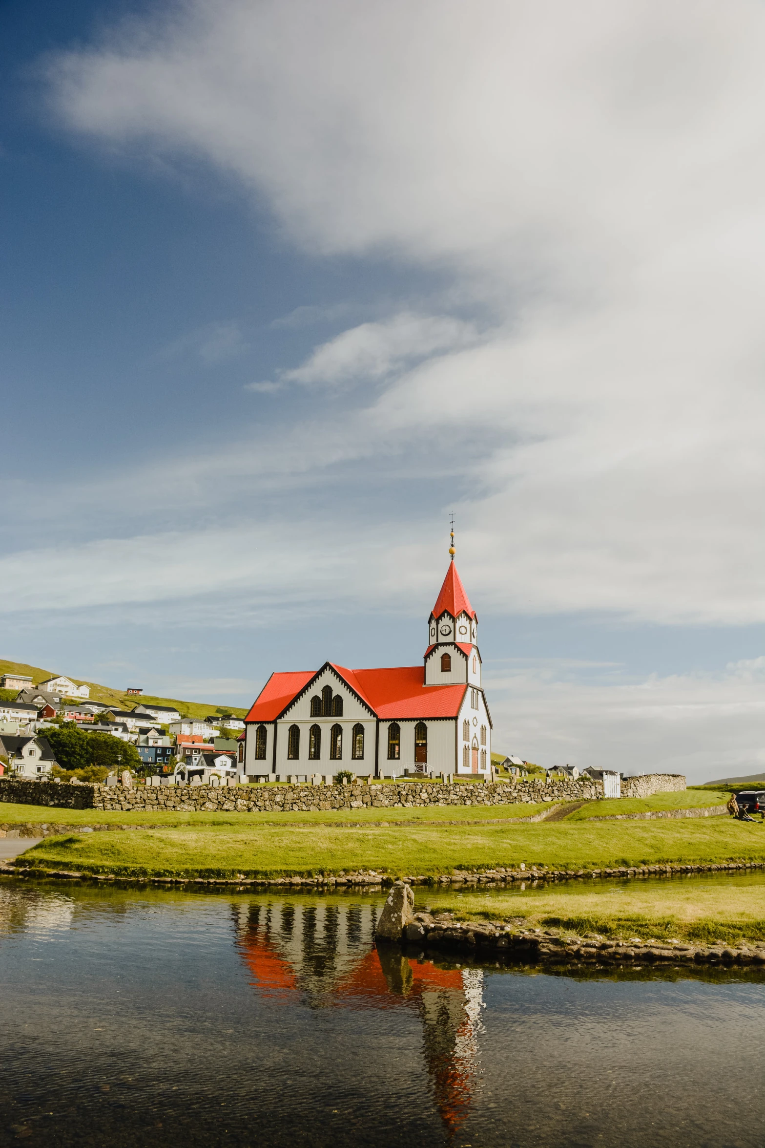 an old building near the water and a lot of land