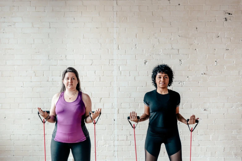 two young women are shown doing cross training