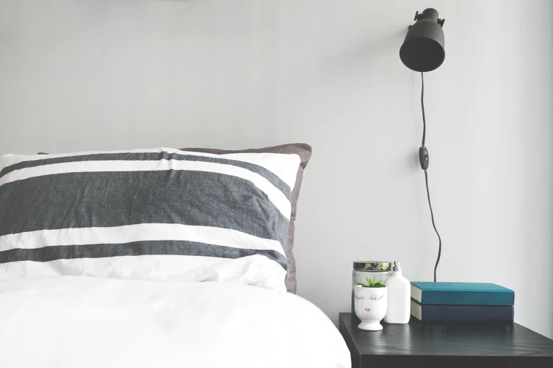 an image of a bedroom setting with nightstand and lamp