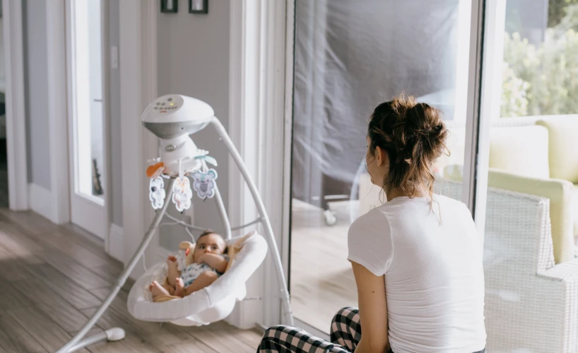 a woman watching herself sitting in her new baby seat