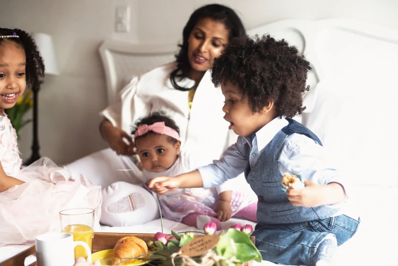 a child and three adults at a breakfast table