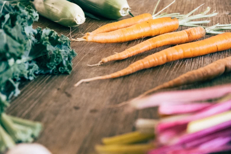 some carrots and broccoli are on a table