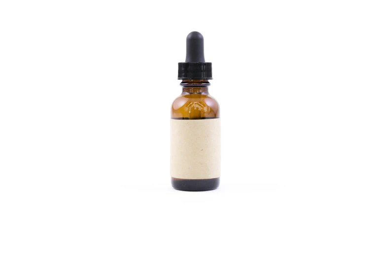 a small bottle of cbd sitting on a white surface