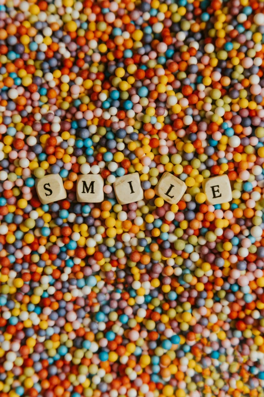 a mixture of candy coated sweets sitting on top of a table