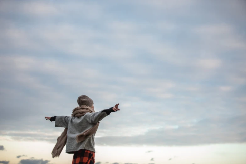 a person flying a kite at the same time as they walk