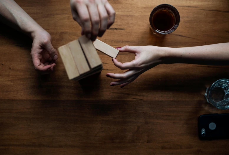 two people are making an object out of wood