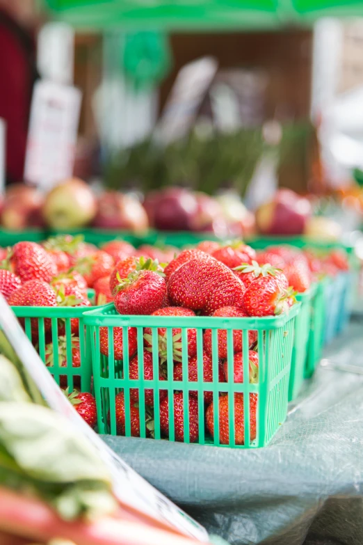 some baskets of red berries are sitting on the counter