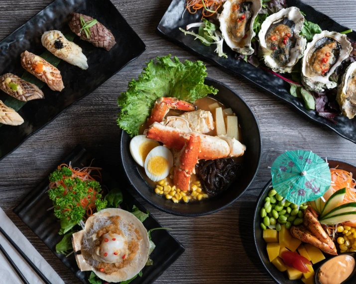 a close up of many plates with seafood