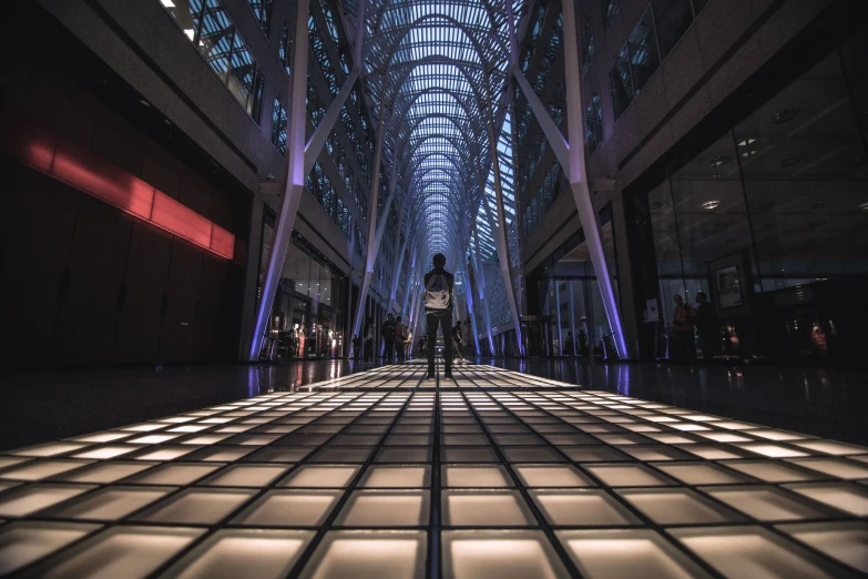 the interior of an indoor atrium with people walking