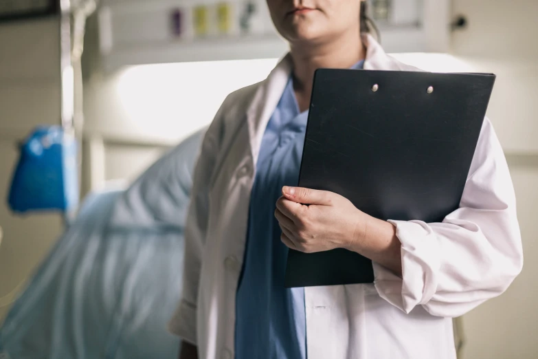 a person with glasses holding a clipboard