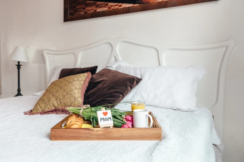 a tray of fresh fruit and veggies is on the bed