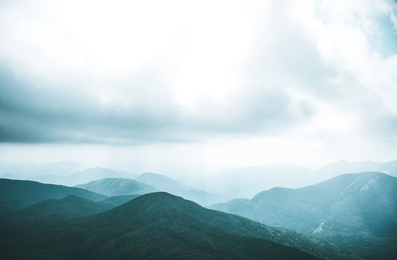 a view of a mountainous range as the sun is setting